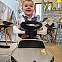 Luka Vucic participe au concours pour gagner de l'argent avec cette photo : baby, brick_wall, chair, child, cute, fridge_magnet, happy, indoors, kitchen, lamp, plant, portrait, refrigerator, ride_on_toy, smiling, steering_wheel, table, tile_floor, toy_car, window