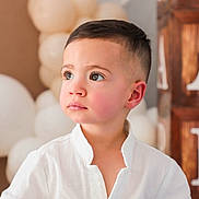 Gianluca joined the competition — help win amazing prizes! toddler, child, boy, portrait, face, white_shirt, balloons, wooden_blocks, letters, short_hair, indoors, soft_light, celebration, cute, innocence, looking_away, young_child, background_blur, casual_clothing, event