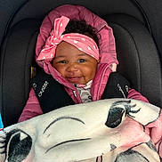 Anaiylah-Rea is registered to the contest to win money with this photo: baby, smile, headband, pink_jacket, blanket, car_seat, child, cozy, cute, infant, apparel, face, happy, indoors, person, portrait, seatbelt, warm, toddler, wrapped