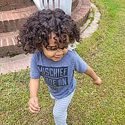 Elam is registered to the contest to win money with this photo: backyard, child, clothing, curlyhair, face, female, girl, grass, hair, head, lawn, nature, outdoors, pants, person, photography, plant, portrait, t_shirt, yard