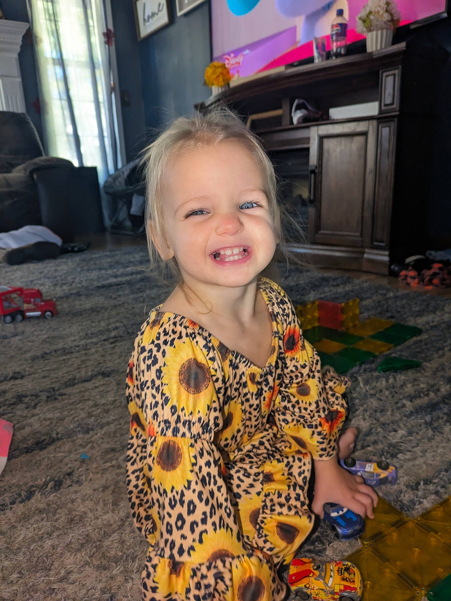 Alaina is registered to the contest to win money with this photo: cabinetry, child, curtain, drawer, floor, flooring, fun, happy, holiday, joy, leisure, pattern, people, person, play, sitting, sleeve, smile, t_shirt, television