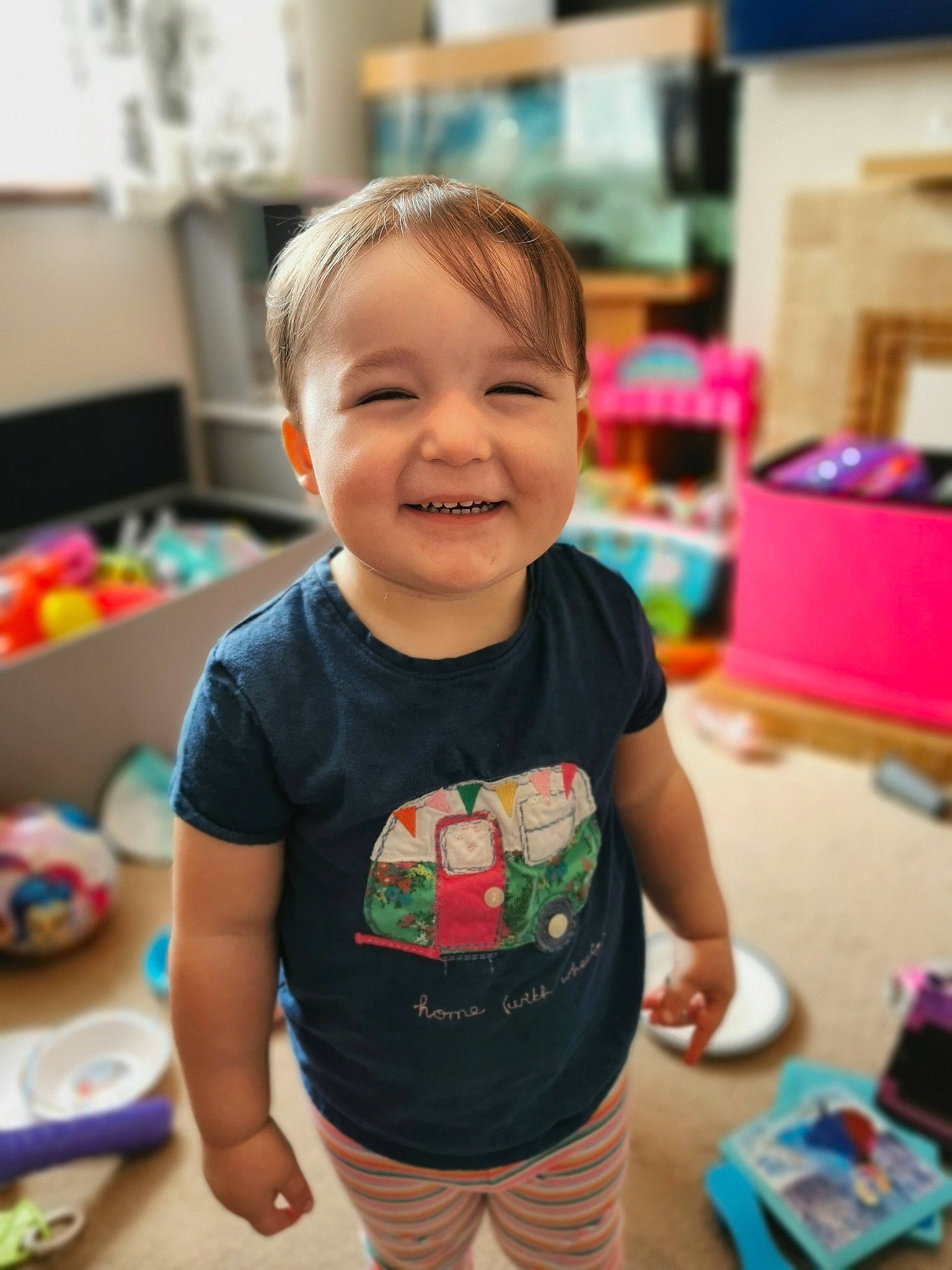 Mia is registered to the contest to win money with this photo: baby, cheek, child, face, facial_expression, fun, happy, head, joy, kindergarten, neck, person, pink, play, skin, smile, standing, t_shirt, toddler, top