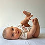 baby, infant, child, lying_down, onesie, toes, hands, eyes, smile, portrait, playful, adorable, bare_feet, bedding, head, smooth_skin, neutral_background, indoor, cute, person