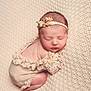accessories, baby, blanket, bodypart, bonnet, clothing, dress, face, finger, glove, hand, happy, hat, head, newborn, person, photography, portrait, sleeping, smile