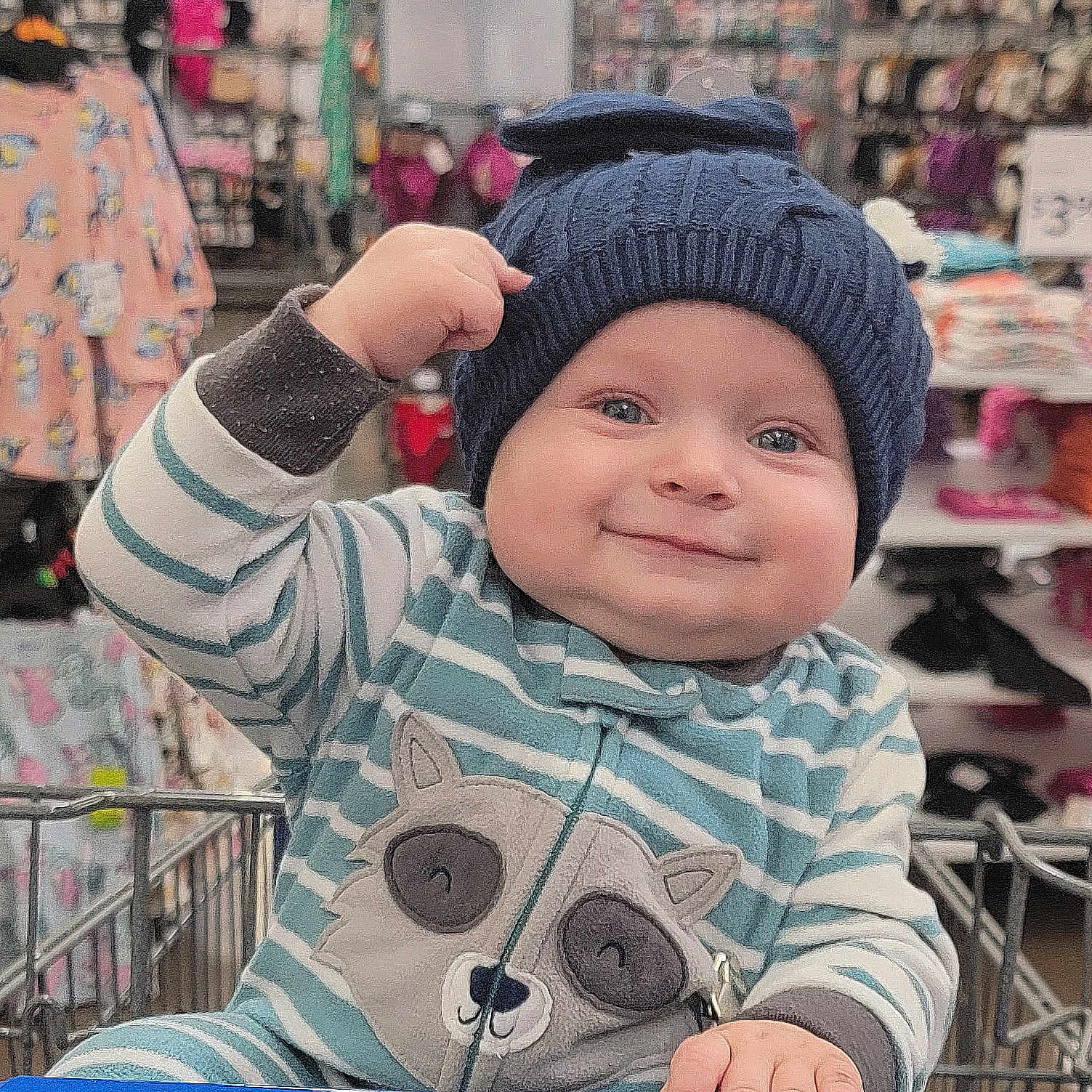 Bronc is registered to the contest to win money with this photo: baby, beanie, bodypart, bonnet, cap, clothing, face, finger, hand, hat, head, indoors, knitwear, pants, person, photography, portrait, shopping, sweater, sweatshirt