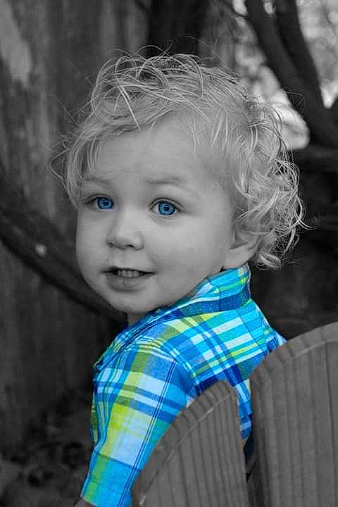 Houston is registered to the contest to win money with this photo: baby_toddler_clothing, chin, eye, flash_photography, hair, hairstyle, happy, iris, leaf, lip, people_in_nature, person, plaid, skin, smile, standing, style, tartan, toddler, tree