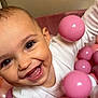 baby, smiling, child, face, pink, balls, ball_pit, white_clothing, happy, play, cute, infant, closeup, indoors, cheerful, skin, eyes, mouth, tongue, fun
