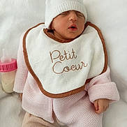 Rose a rejoint le concours — aidez-le/la à gagner de superbes lots ! baby, newborn, sleeping, bib, knit_hat, bunny_ears, pink_clothing, striped_sock, baby_bottle, blanket, soft_texture, infant, cute, peaceful, portrait, indoor, cozy, small_hand, face, resting