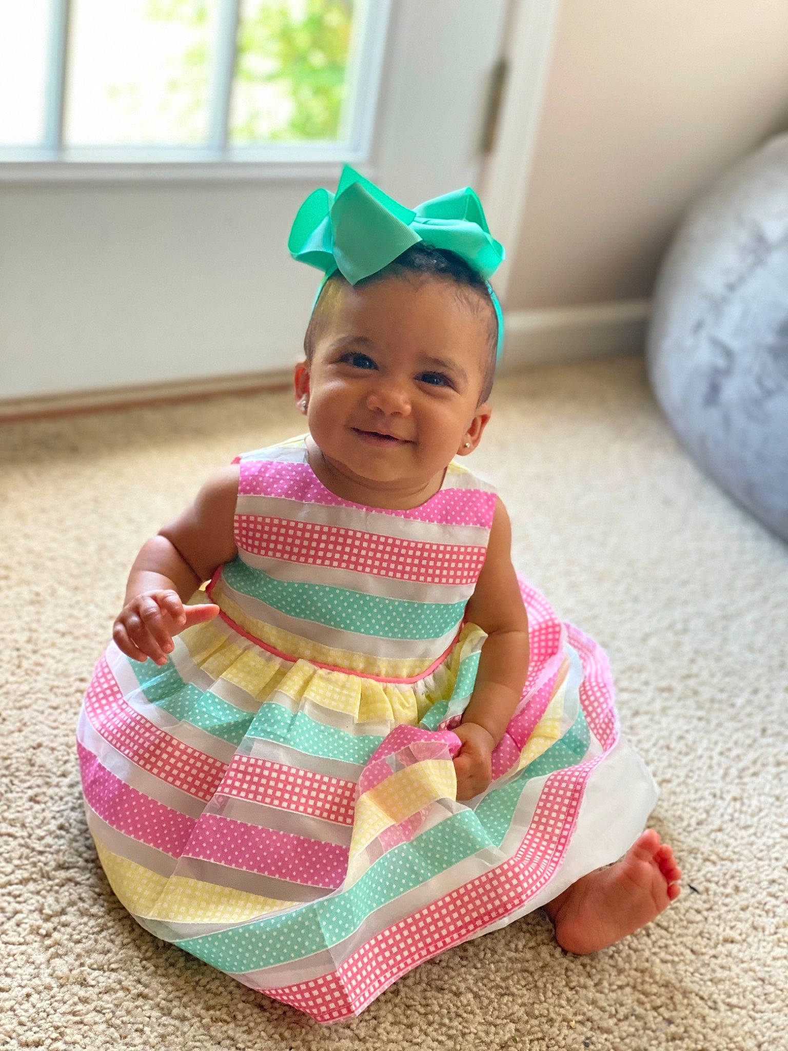 Kynleigh is registered to the contest to win money with this photo: baby, baby_toddler_clothing, cap, dress, fashion_accessory, flooring, fun, grass, happy, headgear, joy, magenta, pattern, person, pink, purple, skin, sleeve, smile, t_shirt