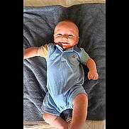 Vincent joined the competition — help win amazing prizes! baby, smiling, blue_romper, blanket, infant, lying_down, cute, happy, child, indoors, one_person, casual_clothing, portrait, skin, head, arms, legs, comfortable, young_child, soft_texture