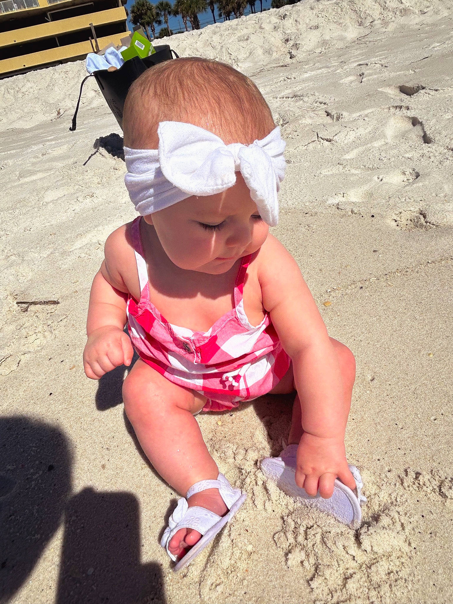 Gracelynn joined the competition — help win amazing prizes! baby_toddler_clothing, beach, cap, child, eyewear, fun, grass, happy, headgear, headwear, human_leg, landscape, leisure, mammal, people_in_nature, person, recreation, sand, sitting, soil