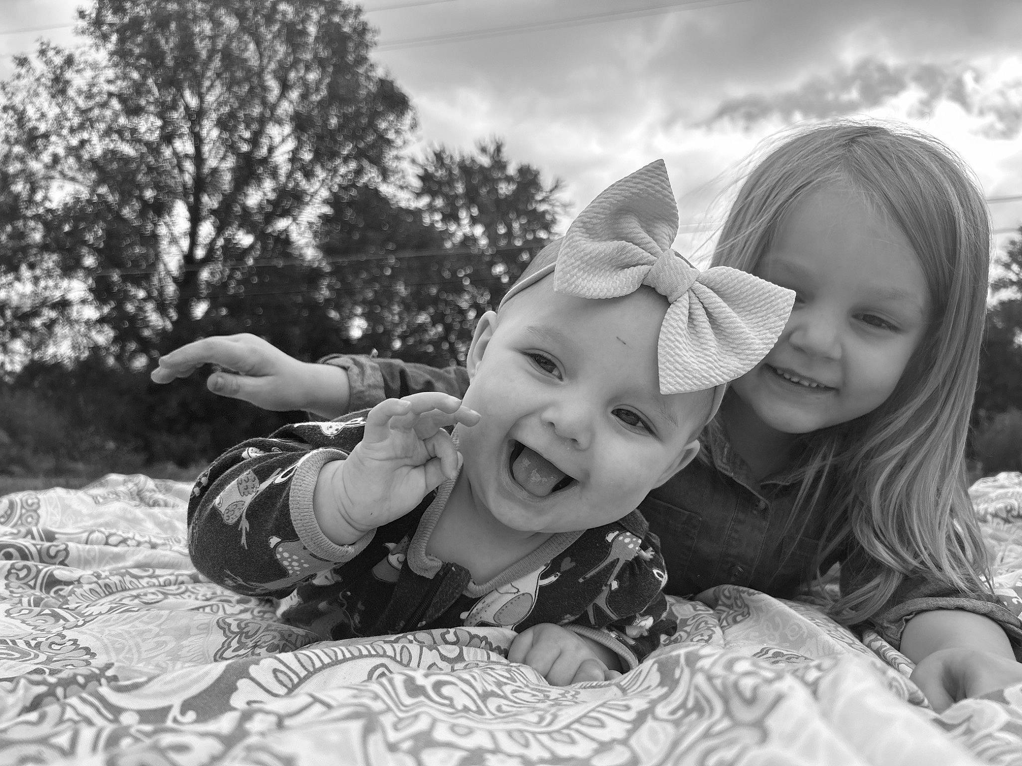 Gracelynn joined the competition — help win amazing prizes! black, black_and_white, cloud, flash_photography, gesture, grass, hand, happy, hat, headwear, monochrome, monochrome_photography, people_in_nature, person, photograph, plant, sky, smile, style, toddler