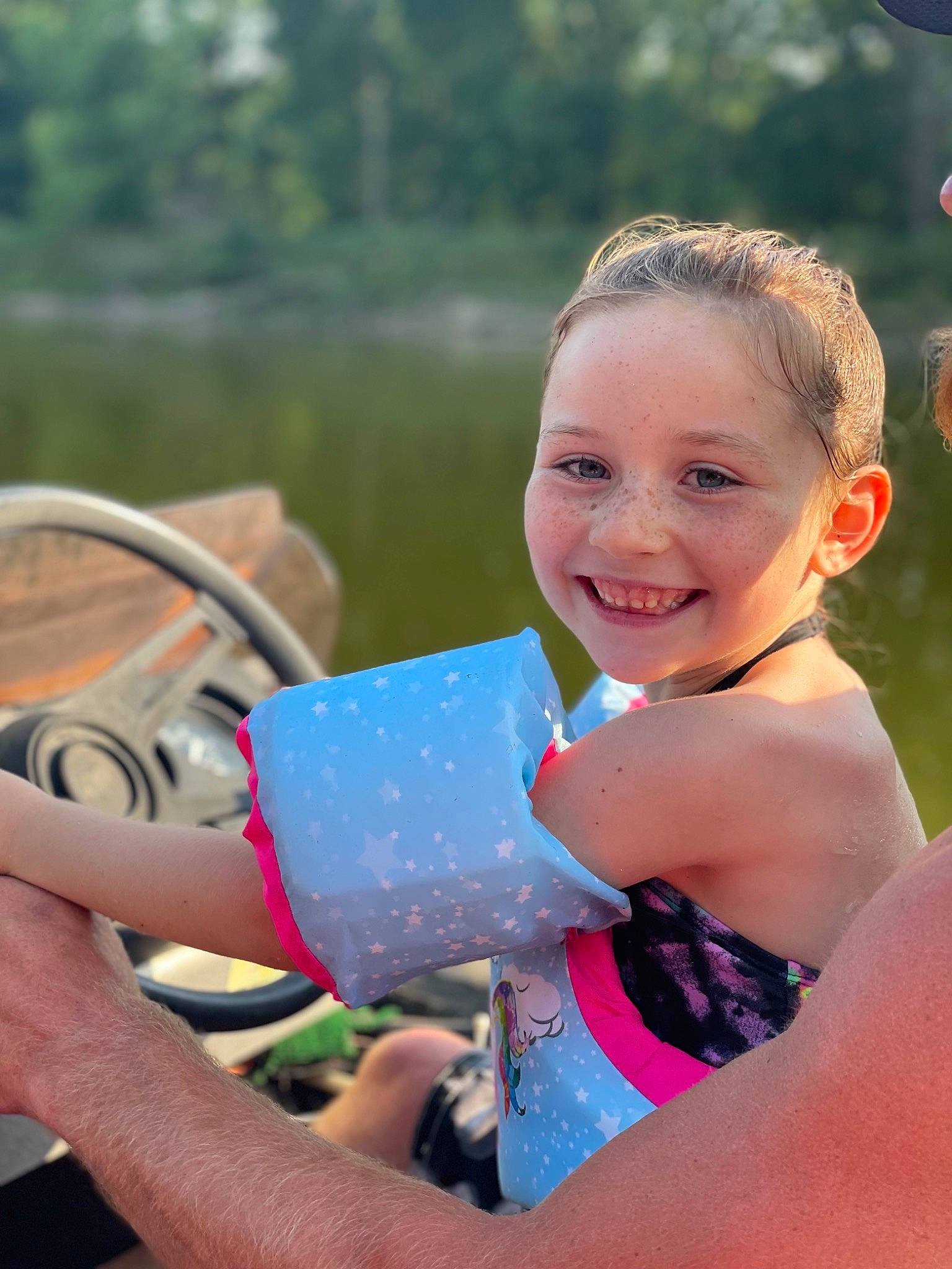 Tenley joined the competition — help win amazing prizes! arm, boats_and_boating_equipment_and_supplies, body_of_water, grass, hand, happy, joy, lake, leisure, morning, outdoor_recreation, people_in_nature, person, personal_protective_equipment, recreation, skin, smile, summer, swimwear, toddler