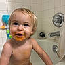 bath_time, bath_toys, bathroom, bathtub, blue_eyes, child, cute, diaper, fun, happy, indoor, messy, playful, smiling, spaghetti_sauce, toddler, water, wet_skin, white_tiles, young_child
