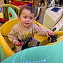 baby, carousel, child, colorful, happy, indoor, kiddie_ride, mall, parent, plastic, playing, portrait, reflection, seat, simba_print, smile, steering_wheel, sweatshirt, toddler, toy_car