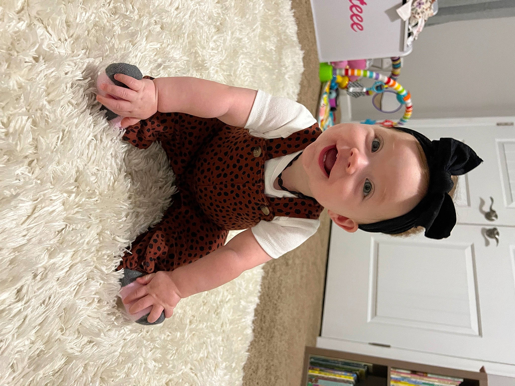 Kennedi is registered to the contest to win money with this photo: baby_toddler_clothing, child, foot, fun, happy, hat, pattern, person, play, room, smile, t_shirt, toddler, vacation, wood