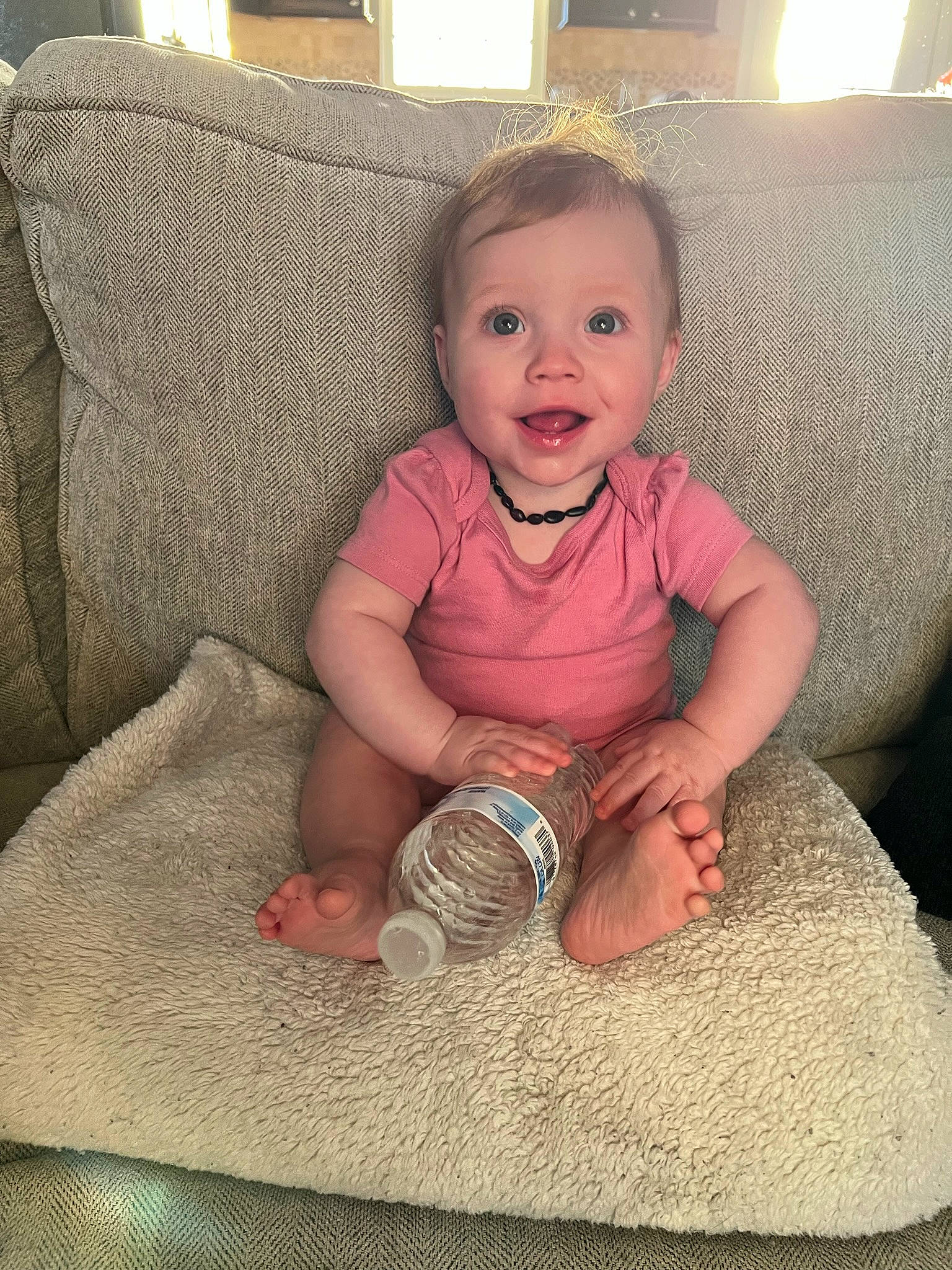 Kennedi is registered to the contest to win money with this photo: baby, baby_toddler_clothing, cheek, child, comfort, couch, finger, flooring, foot, fun, hairstyle, happy, linens, mouth, person, skin, sleeve, smile, thumb, toddler