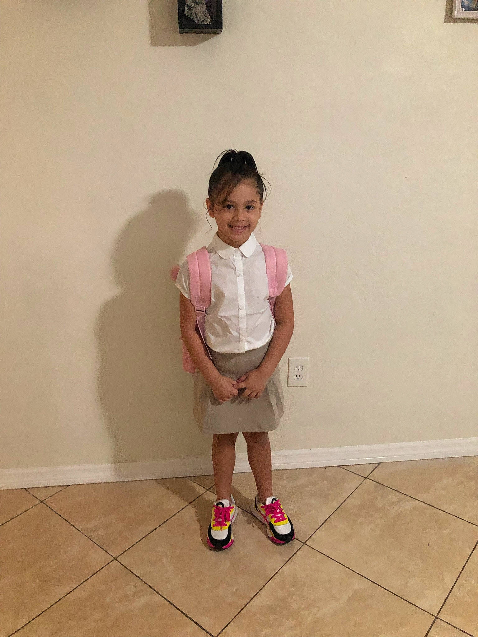 Jenelle is registered to the contest to win money with this photo: child, door, elbow, floor, flooring, fun, happy, hardwood, human_leg, joy, knee, leg, magenta, person, shorts, sleeve, smile, sneakers, thigh, toddler