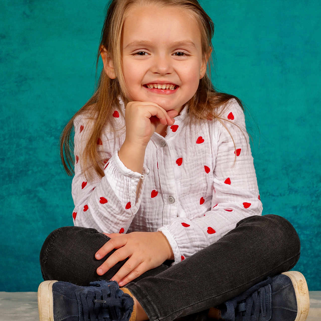 Kaylee participe au concours pour gagner de l'argent avec cette photo : bodypart, child, clothing, face, female, finger, footwear, girl, hand, happy, head, jeans, pants, pattern, person, photography, portrait, shoe, sitting, smile