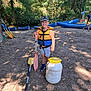 Valentin participe au concours pour gagner de l'argent avec cette photo : child, boy, paddle, life_jacket, cap, canoe, riverbank, trees, outdoor, summer, smile, adventure, nature, water_sport, sand, sunlight, play, recreation, fun, daytime