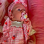 Esmae joined the competition — help win amazing prizes! baby, infant, pacifier, headband, pink, strawberry_pattern, clothing, cushion, soft_toy, stuffed_animal, cute, child, portrait, indoors, resting, hand, face, bed, fabric, sleepwear