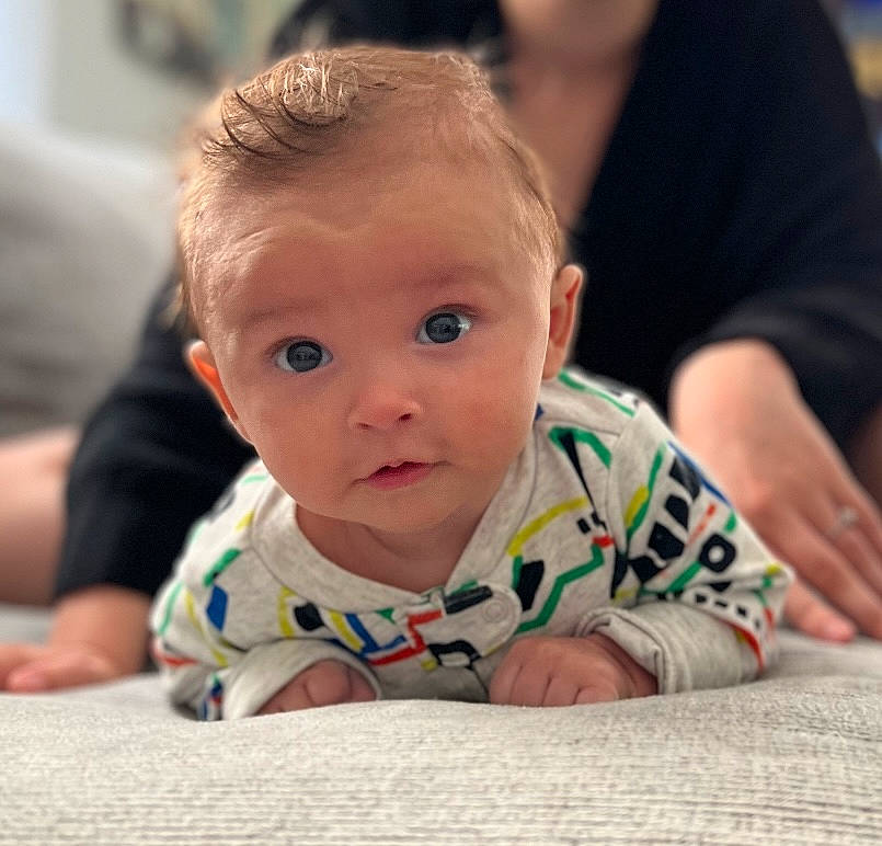 Kamden is registered to the contest to win money with this photo: baby, baby_toddler_clothing, cheek, child, comfort, crawling, floor, flooring, fun, happy, iris, leisure, person, room, sitting, skin, sleeve, t_shirt, toddler, tummy_time