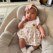 Ava joined the competition — help win amazing prizes! baby, infant, girl, headband, bow, dress, floral, socks, baby_chair, plush, comfort, indoor, floor_tiles, cabinet, home, person, cute, portrait, child, seated