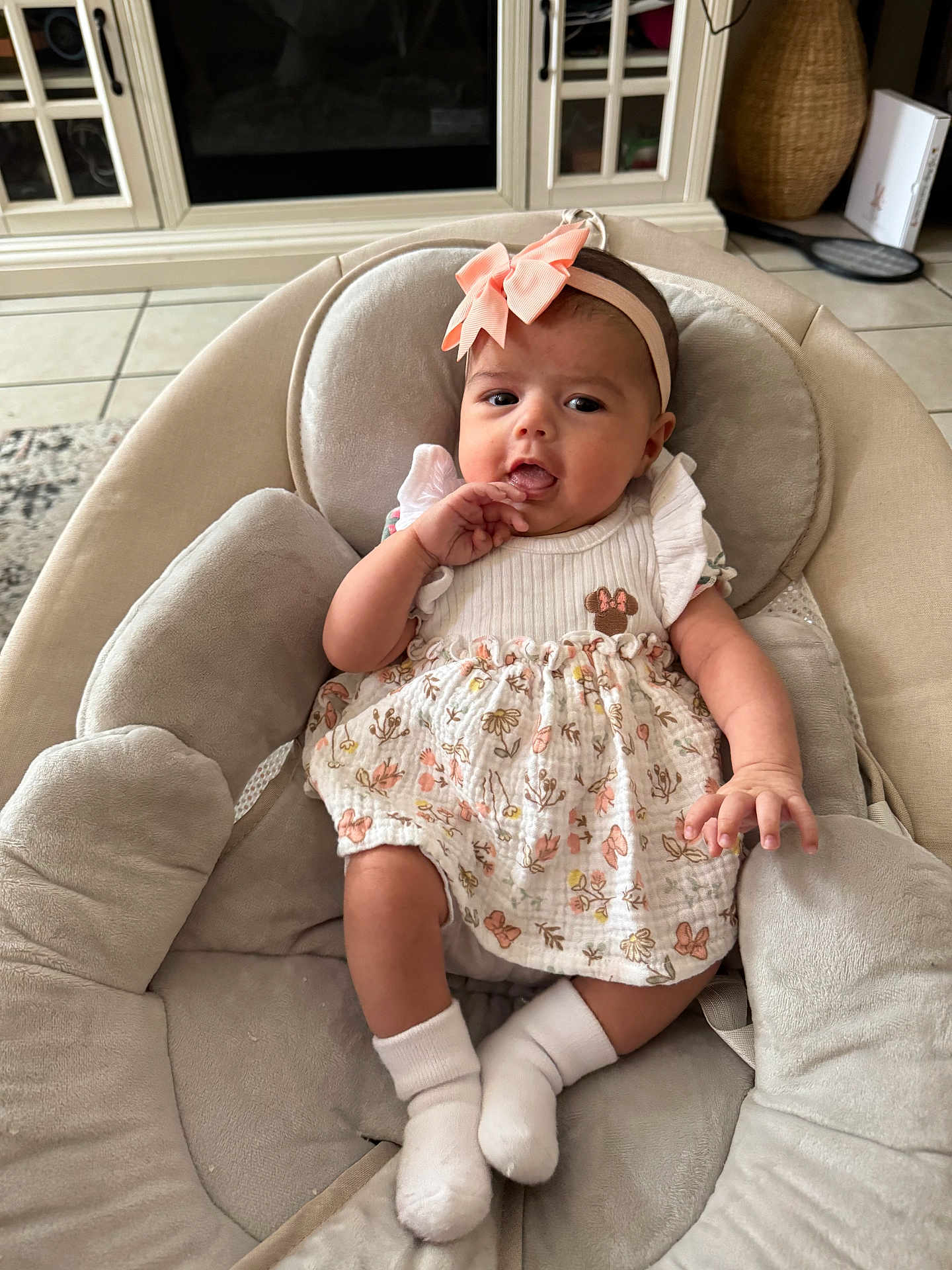 Ava joined the competition — help win amazing prizes! baby, infant, girl, headband, bow, dress, floral, socks, baby_chair, plush, comfort, indoor, floor_tiles, cabinet, home, person, cute, portrait, child, seated