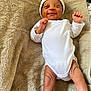 Jaïlan a rejoint le concours — aidez-le/la à gagner de superbes lots ! baby, newborn, infant, smiling, white_onesie, hat, towel, lying_down, happy, skin, cute, small_hands, small_feet, sleepy, cozy, child, person, indoors, soft_texture, peaceful