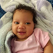 Loriena joined the competition — help win amazing prizes! baby, smile, pink_clothing, towel, curly_hair, face, infant, happy, cute, child, skin, portrait, lying_down, closeup, soft_texture, blanket, person, indoors, young_child, cozy