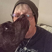 Leady is registered to the contest to win money with this photo: person, dog, beanie, glasses, indoor, affection, closeup, casual, pet, companion, necklace, shirt, animal, face, love, friendship, headwear, mammal, comfort, bond