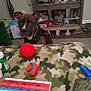 Leady is registered to the contest to win money with this photo: dog, table, pill_organizer, ball, toy, harness, camo_pattern, shelf, bottle, container, indoor, carpet, clutter, blur, pet, brown, black, plastic, medicine
