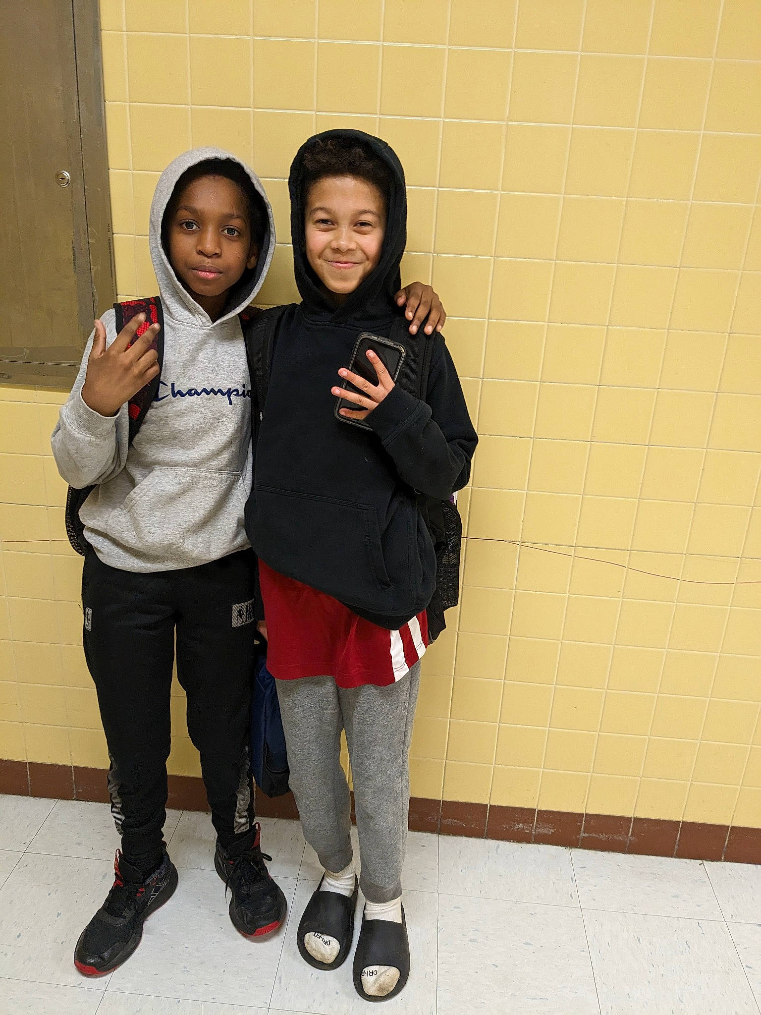 Gabe is registered to the contest to win money with this photo: boot, child, event, flooring, fun, gesture, happy, joy, knee, person, room, sleeve, smile, standing, t_shirt, thigh, uniform, waist