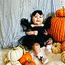Audrey is registered to the contest to win money with this photo: baby, child, pumpkin, black_dress, headband, socks, white_socks, orange_pumpkin, white_pumpkin, fall_decor, seasonal, cute, smiling, portrait, indoor, fluffy_surface, holiday_theme, festive, decorations, happy