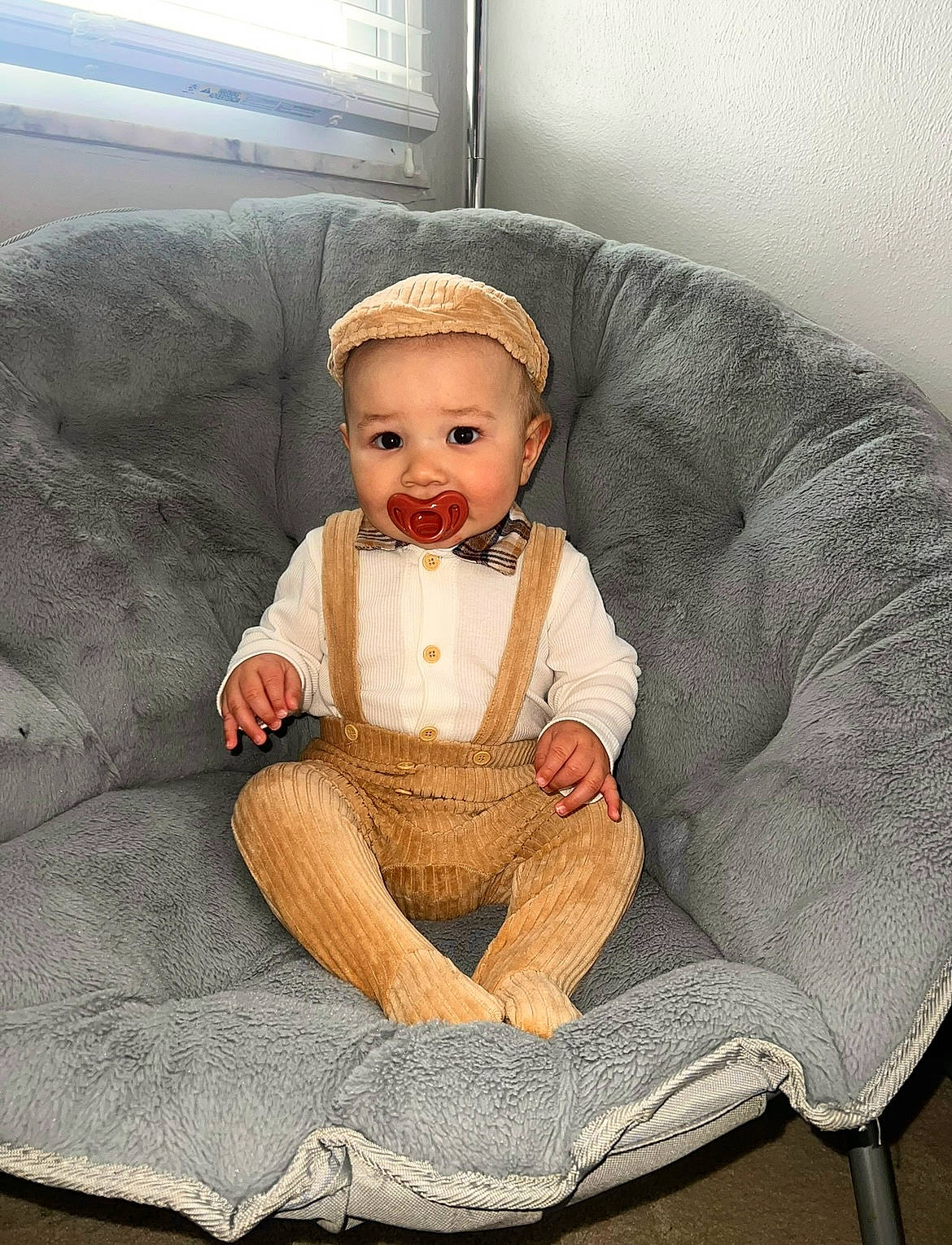 Laron is registered to the contest to win money with this photo: art, baby, baby_products, baby_toddler_clothing, chair, child, comfort, costume_hat, couch, eye, headgear, knee, lap, linens, person, sitting, sleeve, smile, toddler, vintage_clothing