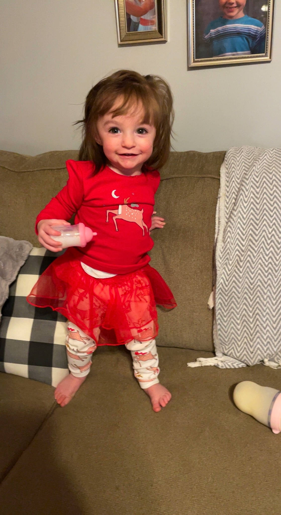 Emerly is registered to the contest to win money with this photo: baby_toddler_clothing, cheek, child, comfort, couch, finger, floor, flooring, fun, hair, happy, human_leg, joy, leg, person, picture_frame, sitting, skin, sleeve, smile