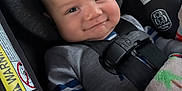 Zayden joined the competition — help win amazing prizes! baby, blanket, car_seat, child, closeup, clothing, cozy, cute, face, happy, head, indoor, infant, person, safety, seatbelt, smile, straps, transportation, warning_label