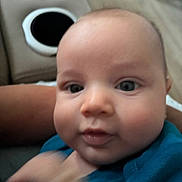 Zayden joined the competition — help win amazing prizes! baby, child, face, closeup, blur, motion, teal_clothing, couch, cup_holder, furniture, indoor, floor, person, skin, head, cheeks, eyes, mouth, hand, infant