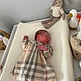 baby, sleeping, plaid_dress, white_leggings, changing_pad, plush_bunny, toy_duck, nursery, basket, soft_surface, infant, peaceful, child, indoors, bedroom, cute, resting, furniture, decor, newborn