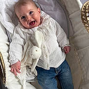 Gabrielle participe au concours pour gagner de l'argent avec cette photo : baby, bassinet, blanket, blue_jeans, bunny, child, clothing, comfort, cozy, cute, happy, indoors, infant, person, plush_toy, portrait, smile, sock, soft_toy, white_shirt