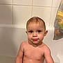 Raphaël participe au concours pour gagner de l'argent avec cette photo : toddler, bathtub, child, wet_hair, bathroom, tiles, skin, face, water_drops, mesh_bag, toys, sitting, curious, indoors, young_child, bath_time, cute, expression, naked, baby