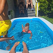 Raylynn joined the competition — help win amazing prizes! child, pool, water, splashing, yellow_shorts, swimming, backyard, porch, people, steps, towel, greenery, sunlight, summer, legs, toes, happy, outdoor, fun, family