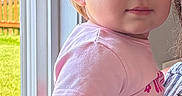 Vivian joined the competition — help win amazing prizes! toddler, child, portrait, indoor, natural_light, pink_shirt, yellow_pants, hair_tied, window, door, backyard, grass, fence, curious, face, person, young_child, casual_clothing, cute, daylight