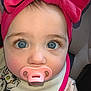 Rhaenyra is registered to the contest to win money with this photo: baby, blue_eyes, pacifier, headband, pink, bow, infant, cute, child, face, portrait, clothing, bib, indoor, closeup, person, expression, young_child, adorable, wearing