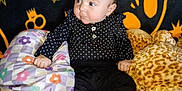Rhaenyra joined the competition — help win amazing prizes! baby, infant, black_clothing, boots, plush_toy, giraffe_toy, pillow, patterned_background, stars, smiley_face, sitting, indoor, cute, child, portrait, soft_toys, colorful, cozy, expression, playful