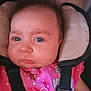 Rhaenyra is registered to the contest to win money with this photo: baby, infant, face, blue_eyes, pink_clothing, car_seat, seatbelt, headrest, pouty_expression, close_up, child, person, young, cute, portrait, sitting, indoors, straps, polka_dots, hair