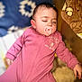 baby, blanket, child, clothing, comfort, cozy, cushion, cute, face, hand, indoor, infant, pacifier, peaceful, pink_onesie, portrait, relaxation, sleeping, soft_texture, young_child