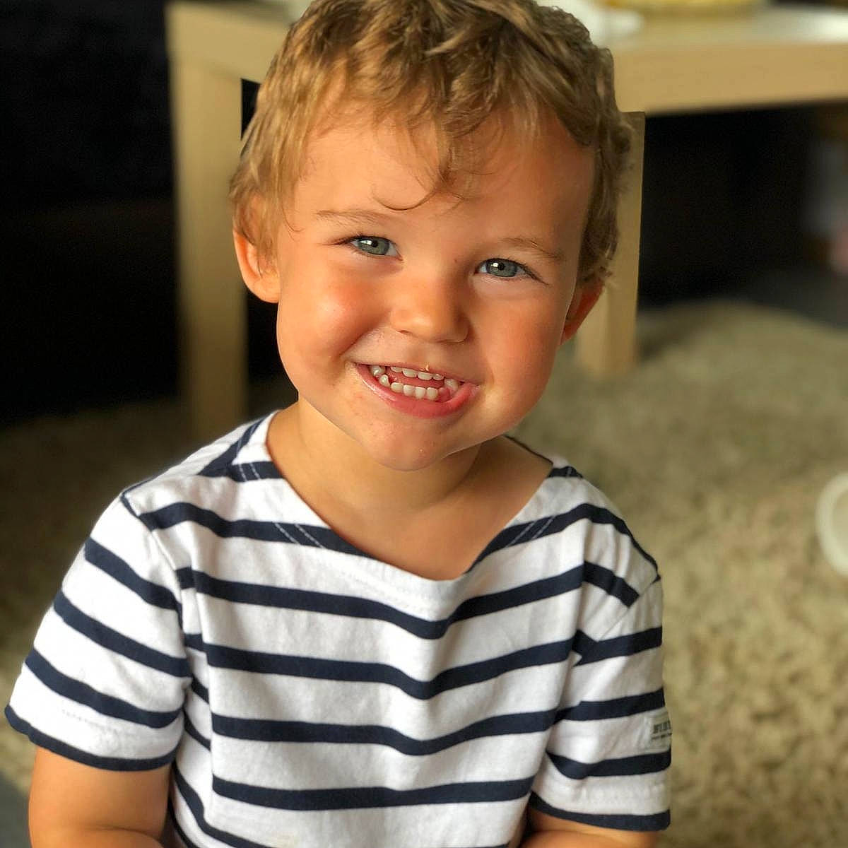 Melvin participe au concours pour gagner de l'argent avec cette photo : baby, baby_toddler_clothing, cheek, child, eyebrow, flooring, forehead, fun, happy, iris, joy, laugh, mouth, neck, nose, person, sitting, skin, sleeve, smile