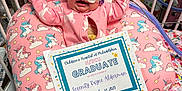 Serenity joined the competition — help win amazing prizes! baby, blanket, celebration, certificate, child, clothing, crib, crying, cushion, face, graduation_cap, hospital, indoors, infant, medical_equipment, neonatal, pediatric, person, pink, unicorn