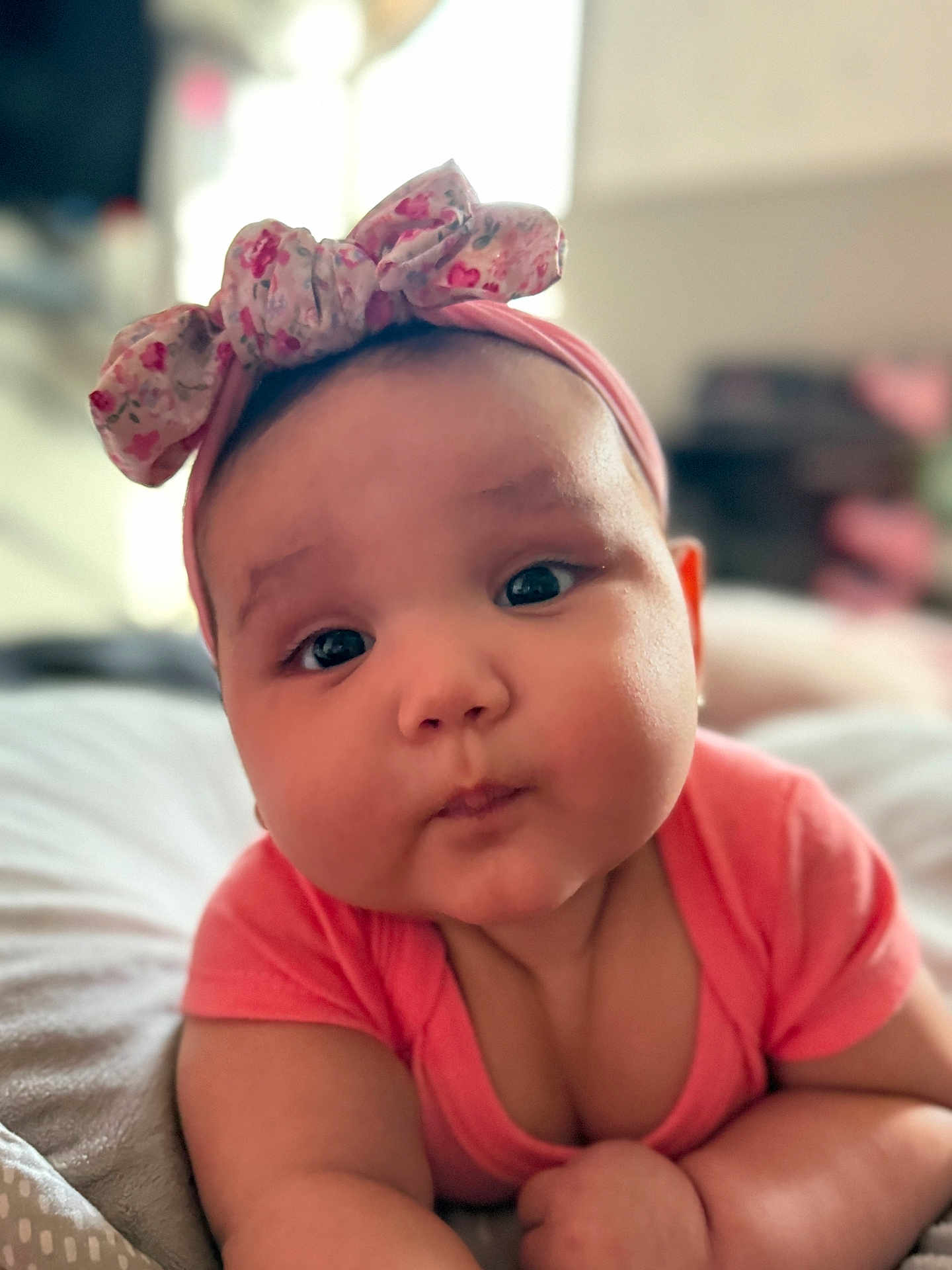 Antonella joined the competition — help win amazing prizes! baby, infant, face, headband, pink_clothing, chubby_cheeks, cute, portrait, lying_down, indoors, soft_light, expression, child, person, closeup, skin, adorable, baby_girl, headwear, toddler
